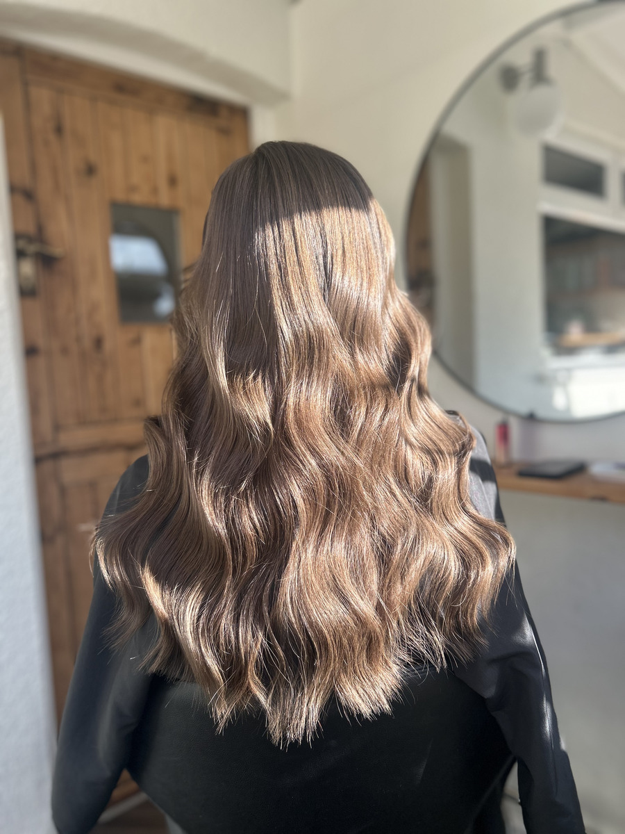 Brunette hair with soft caramel balayage and loose waves